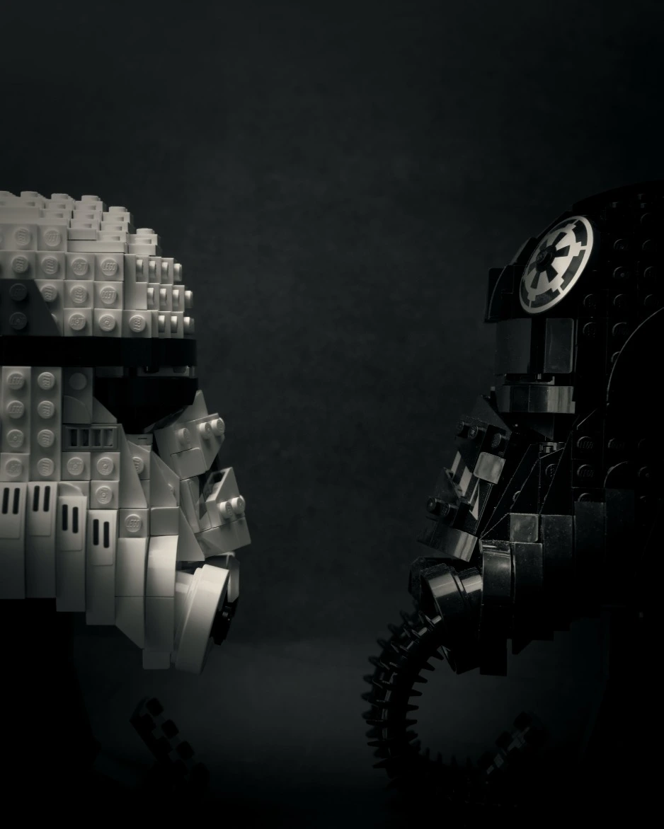 Photo of a stormtrooper and darth maul lego helmets facing each other